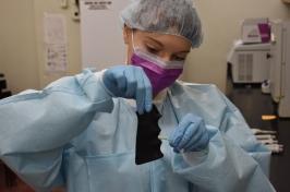 Lab worker swabs a gun grip
